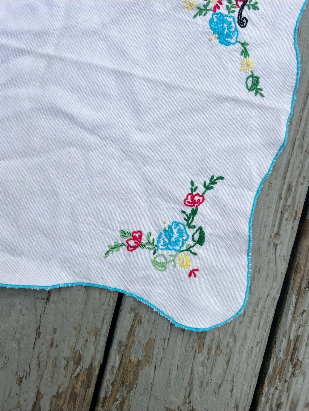 Vintage White Embroidered Table Linen with Blue and Red Floral Accents